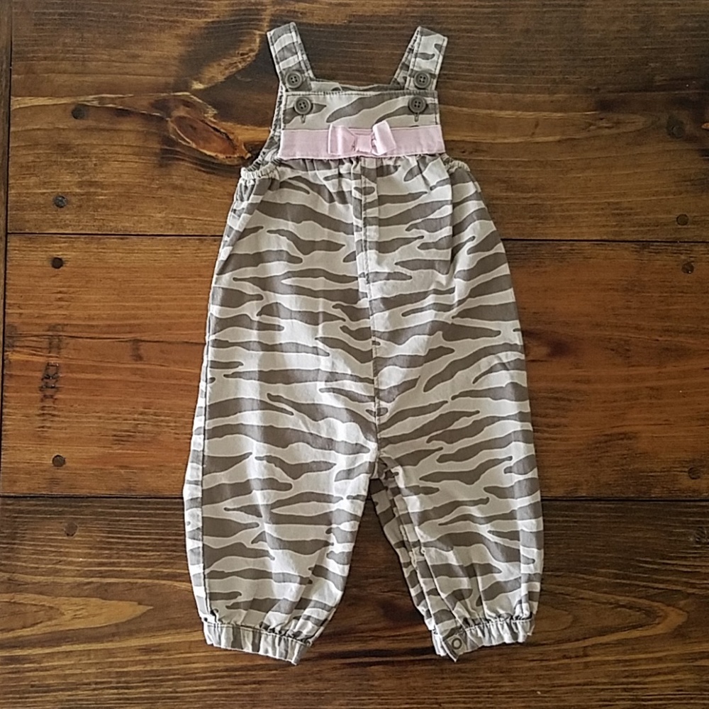 One piece tan zebra jumpsuit with pink bow